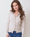 Light oyster-colored button-up cardigan sweater with a soft texture, worn with blue jeans.