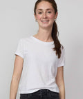 White short-sleeve baby tee with a relaxed fit worn with black jeans.