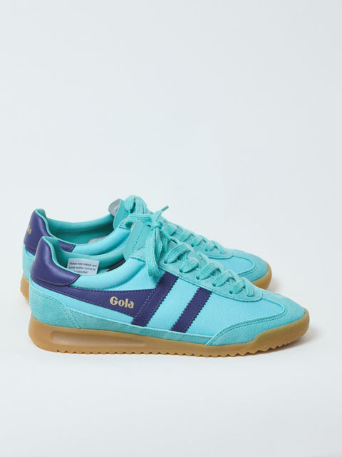 A pair of Gola branded low-top sneakers with contrasting side stripes, featuring a blue upper with purple suede trims and a beige sole.