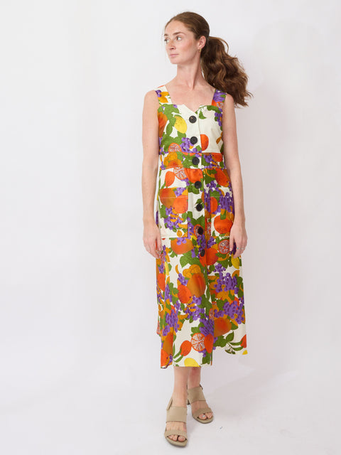 Woman wearing a colorful floral dress on a white background