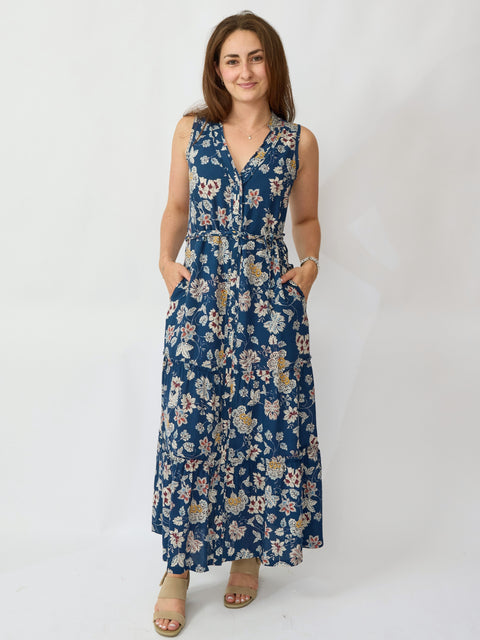Woman wearing a blue floral dress against a white background