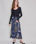Blue midi skirt with abstract white and yellow brushstroke pattern, flowing silhouette.