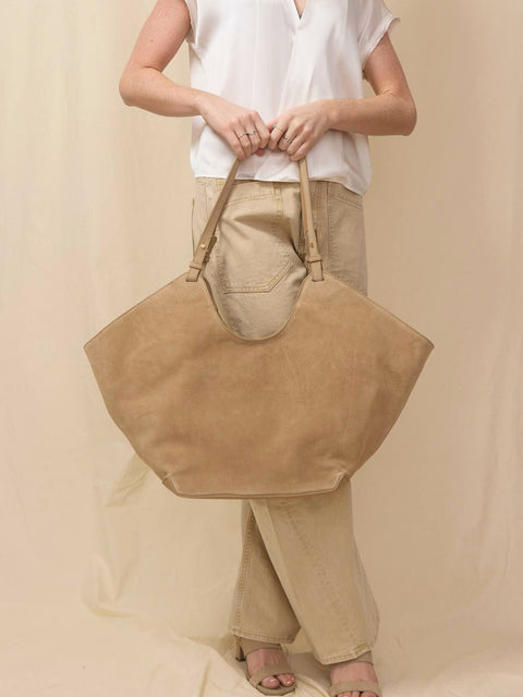 chic tan suede tote bag on monochromatic backdrop