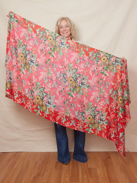 Blond woman holds a large wool floral shawl