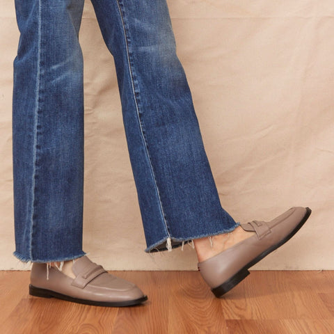 chic taupe loafers close up photo on woman wearing denim