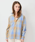 Camel and blue check long-sleeve button-up shirt with pointed collar, worn by model.