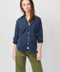 Navy blue button-up shirt with vertical textured white stripes and rolled-up sleeves.