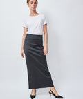 Woman wearing a white t-shirt and black skirt on a white background