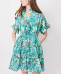 Green floral short dress with ruffled sleeves and cinched waist.