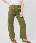 Olive green soft denim utility pants with relaxed straight legs and front pockets worn with sandals.