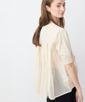 Light beige semi-sheer blouse with puff sleeves and pleated back detail.