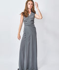 Woman wearing a gray sleeveless dress on a white background