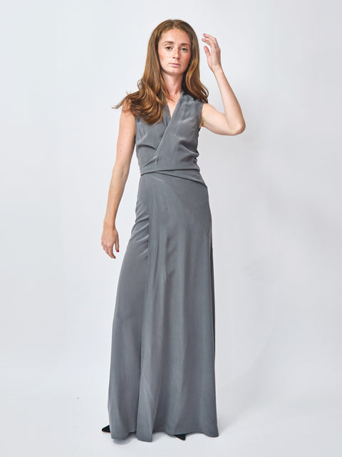 Woman wearing a gray sleeveless dress on a white background