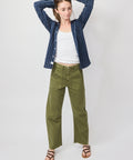 Olive green denim utility soft barrel pants with a relaxed fit, paired with a white tank and navy striped shirt.