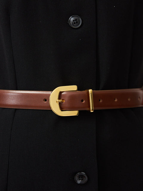 Mahogany leather belt with gold buckle and gold loop on black garment.