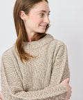 Light beige chunky knit sweater with relaxed fit and wide, cozy crew neckline.