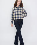 Purple and cream plaid flannel shirt with button-up front and long sleeves.