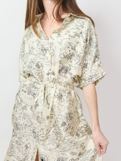 Ecru collared dress with button front, cinched waist, and vintage map print.