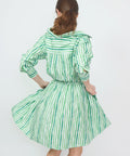 Green and white striped off-the-shoulder mini dress with long sleeves and a flared skirt.