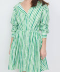 Green and white vertical striped mini dress with off-shoulder neckline and long sleeves.