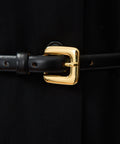Black leather belt with a shiny gold rectangular buckle and rounded edges.