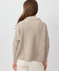 Light beige knit sweater with textured pattern, long sleeves, and relaxed fit.