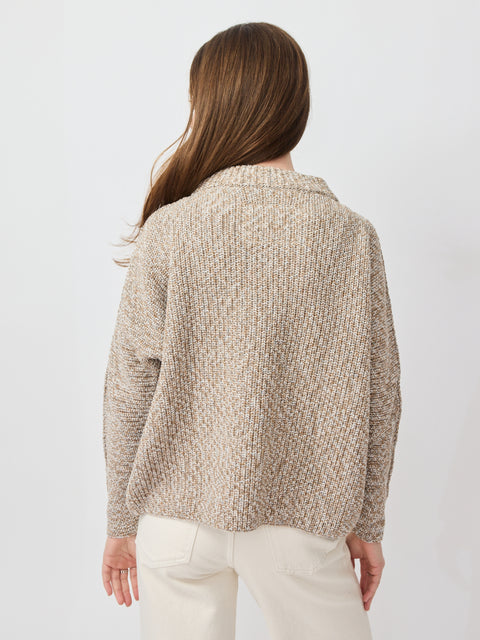 Light beige knit sweater with textured pattern, long sleeves, and relaxed fit.
