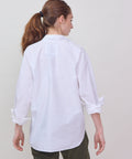 White long-sleeve button-up shirt with a classic collar and relaxed fit, shown from the back.