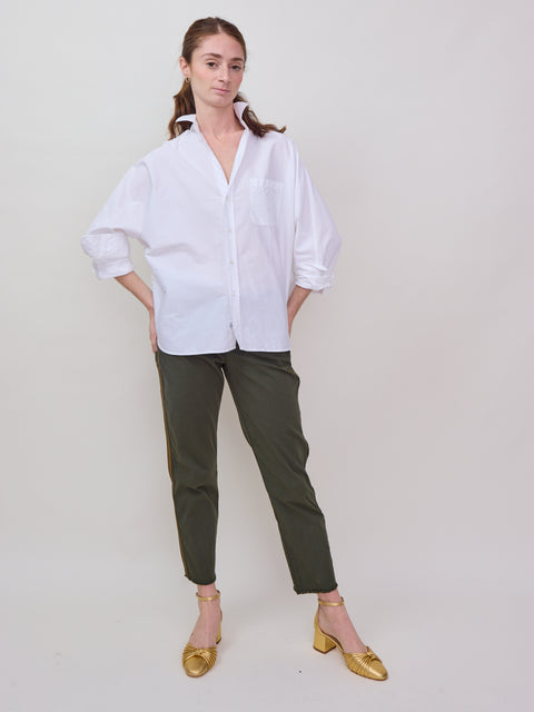 White oversized button-up shirt with long sleeves and a relaxed fit, paired with olive green cropped pants and mustard.