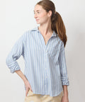 Light blue and white vertical striped button-up shirt with collar, long sleeves, and relaxed fit.
