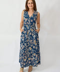 Woman wearing a blue floral dress against a white background