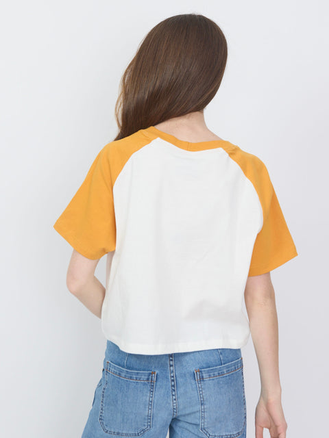White baseball tee with orange raglan sleeves and a relaxed fit, shown from the back.