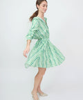 Green and white striped off-shoulder mini dress with long sleeves and a waist tie.