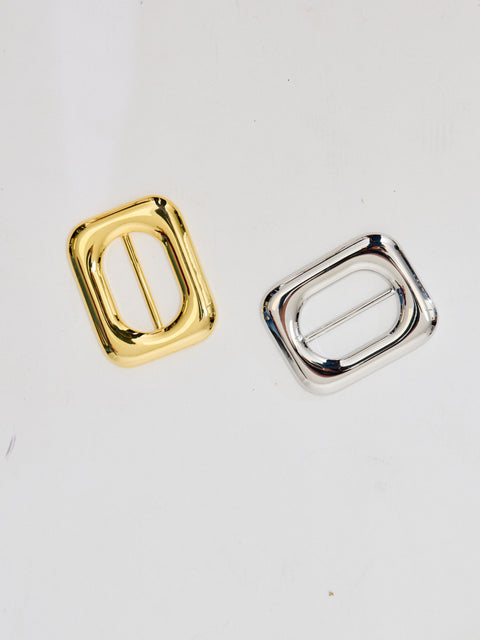Two rectangular belt buckles, one gold and one silver, with rounded edges and open centers.