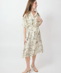 Ecru midi dress with floral print, short sleeves, collar, and waist tie belt.