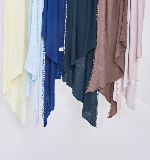 Scarf display with various colors on a white background