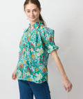 Green puff-sleeve blouse with colorful floral print and loose fit.