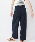 Navy wide-leg pants with high waist and belt loops, made from lightweight fabric.