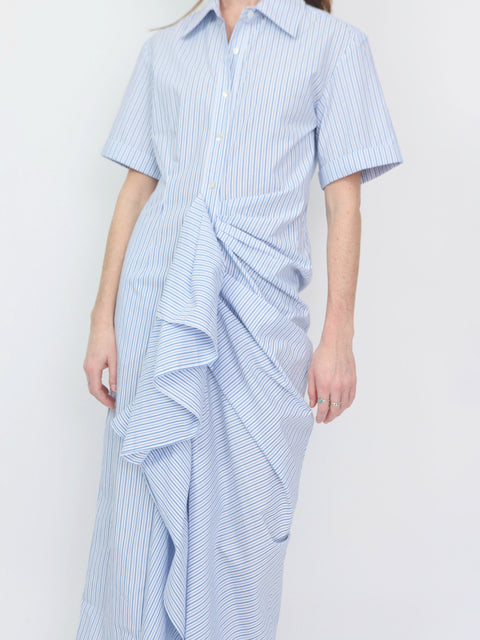 Light blue and white striped shirt dress with short sleeves, collared neckline, button front, and gathered ruffle detailing.