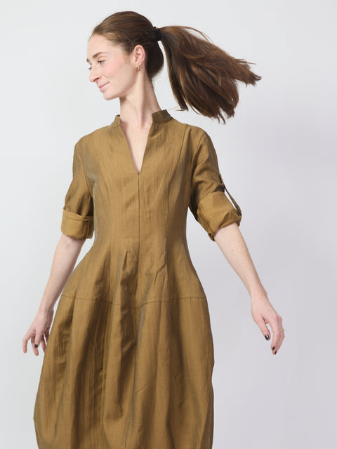 Oak-colored knee-length utility dress with rolled sleeves and a mandarin collar.
