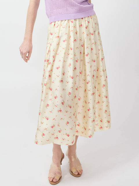 Ecru midi skirt with soft pink floral print and gathered waistband.