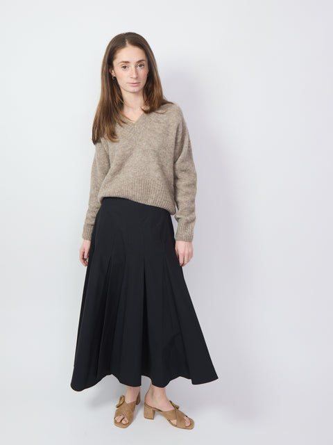 Black high-waisted midi skirt with wide pleats and A-line silhouette.