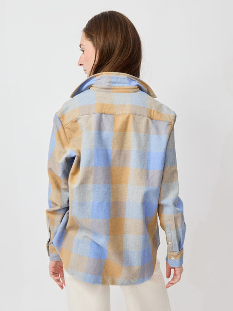 Long-sleeve button-up shirt with camel and blue plaid pattern, relaxed fit, and curved hem.