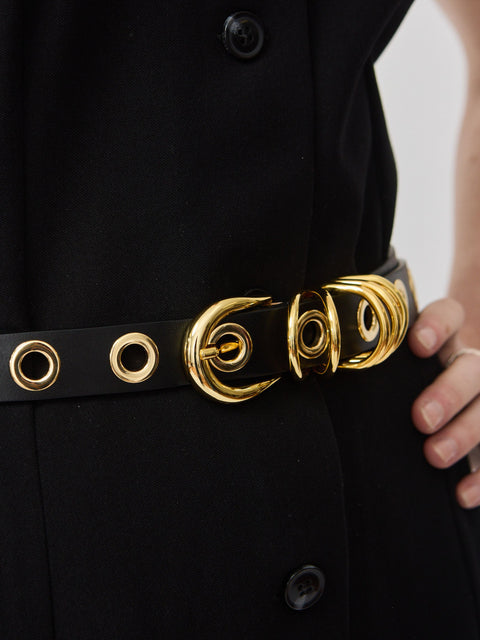 Black belt with gold-tone circular rivet buckle and matching eyelets on smooth leather strap.