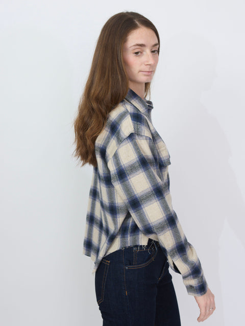 Purple and cream plaid flannel shirt with long sleeves and button-down front.