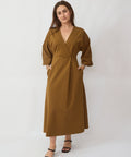 Woman wearing a brown dress against a white background