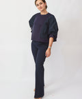Woman wearing a navy blue outfit on a white background