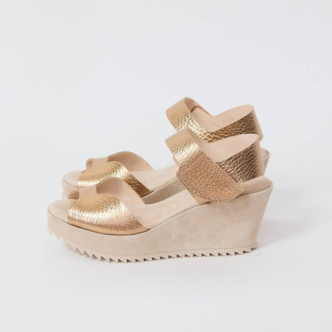 Pair of metallic gold platform sandals with velcro closure.