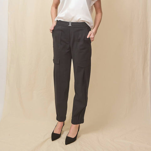 Young lady wears black belted cargo pants with black suede slingback shoes.