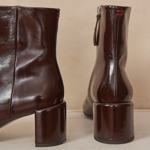 Mid block heel boots in a brown patent leather